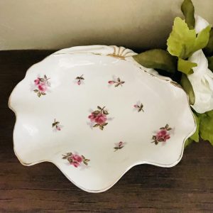Shell shaped porcelain dish with roses on it