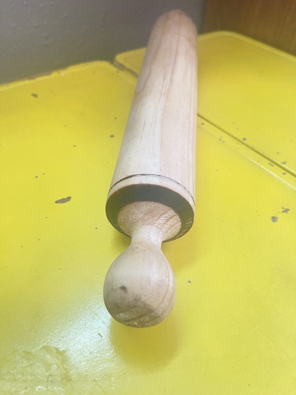 Wood rolling pin on yellow cart